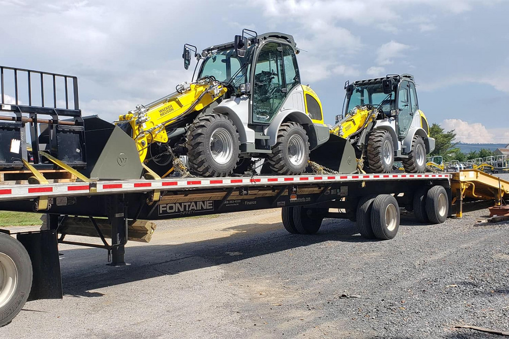 Flatbed loaded with 2 tractors